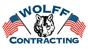 This Logo contains the face of a wolf flanked by two american flags, and the words Wolff Contracting in bold.